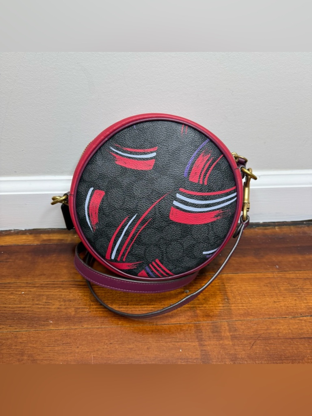 Coach Black Round Crossbody with Red and Purple Brushstroke Detail